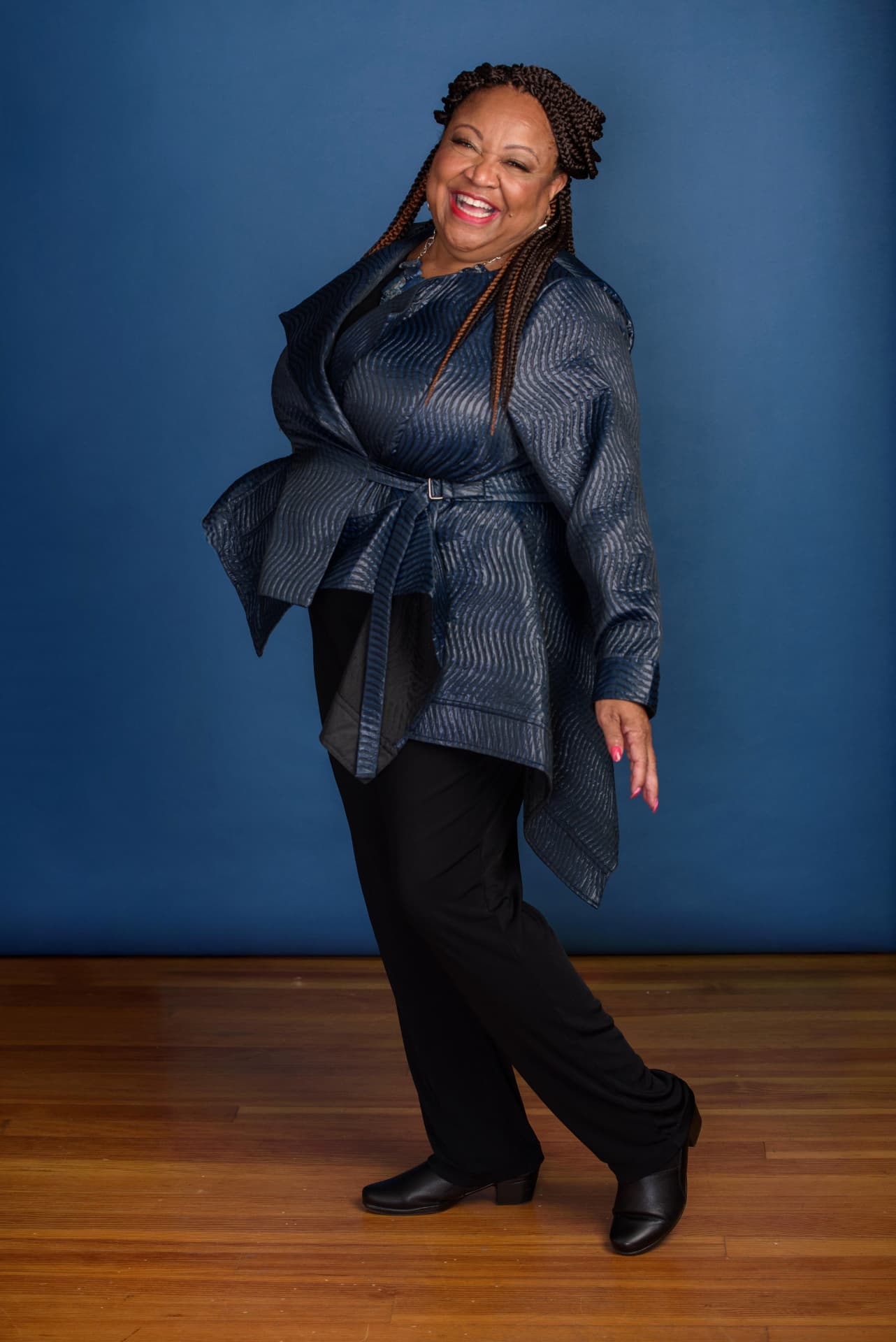 Lynell Renee Green laughing in a blue textured jacket